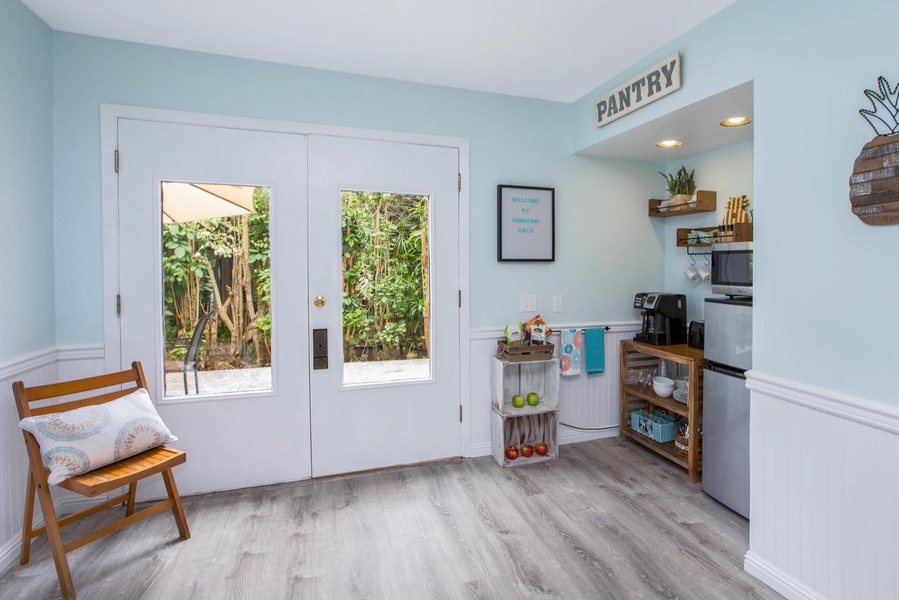 Cozy living area in the studio room with plush seating, tasteful décor, and a large window that fills the space with natural light.