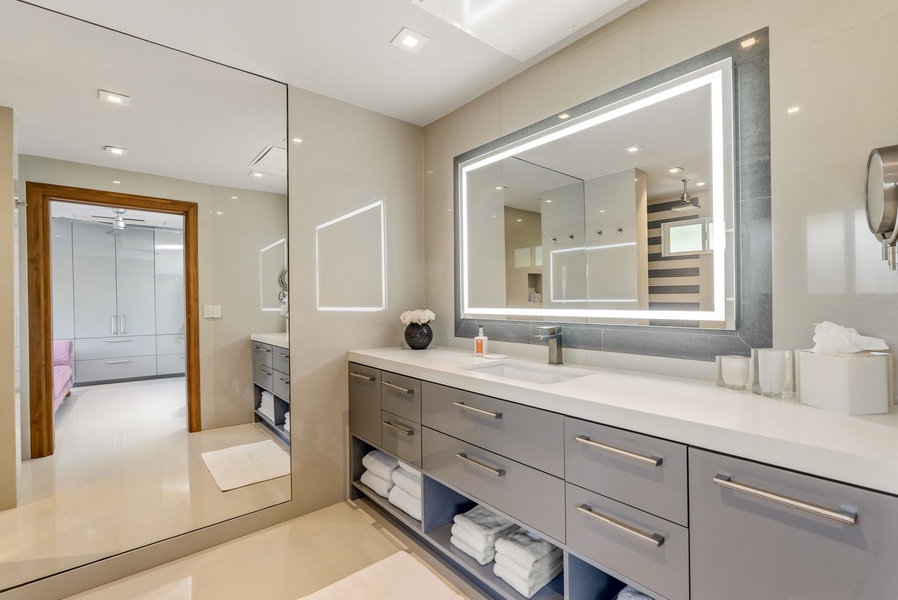 Step into your spa-like bathroom, where sleek modern design meets everyday comfort. Ample counter space and a backlit mirror create an inviting space to start or end your day.