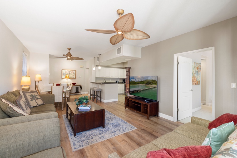Your tropical-themed living space features comfortable seating and a full kitchen, perfect for relaxing after beach adventures.