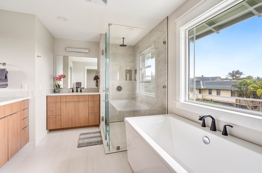 Upstairs ensuite guest bathroom 4 with two sinks, soaking tub, and rainfall shower