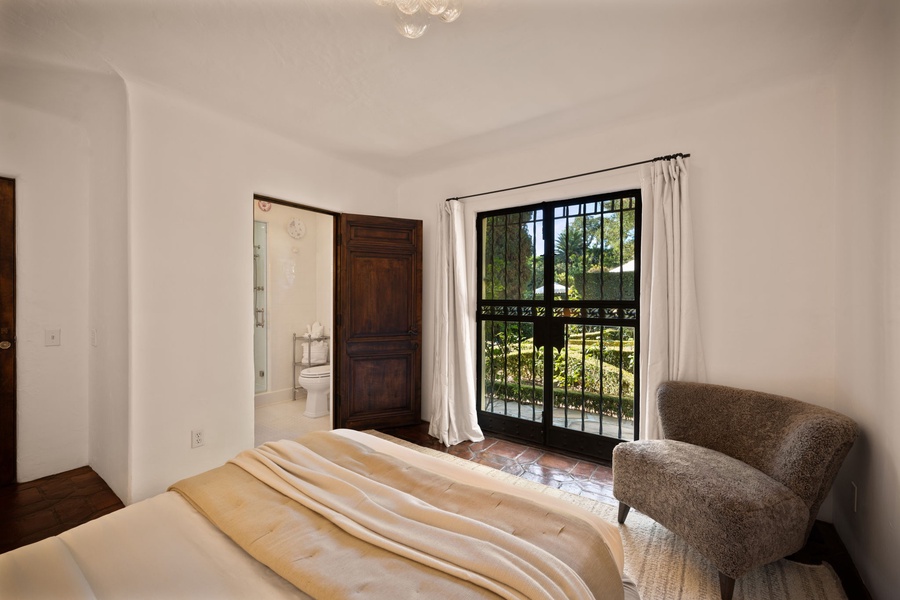 Wake up to sunlight streaming through your private balcony doors, with a cozy reading chair perfectly positioned for morning coffee.