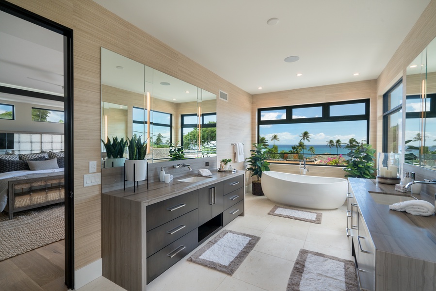 Primary Bedroom ensuite with large vanity and soaking tub with ocean views