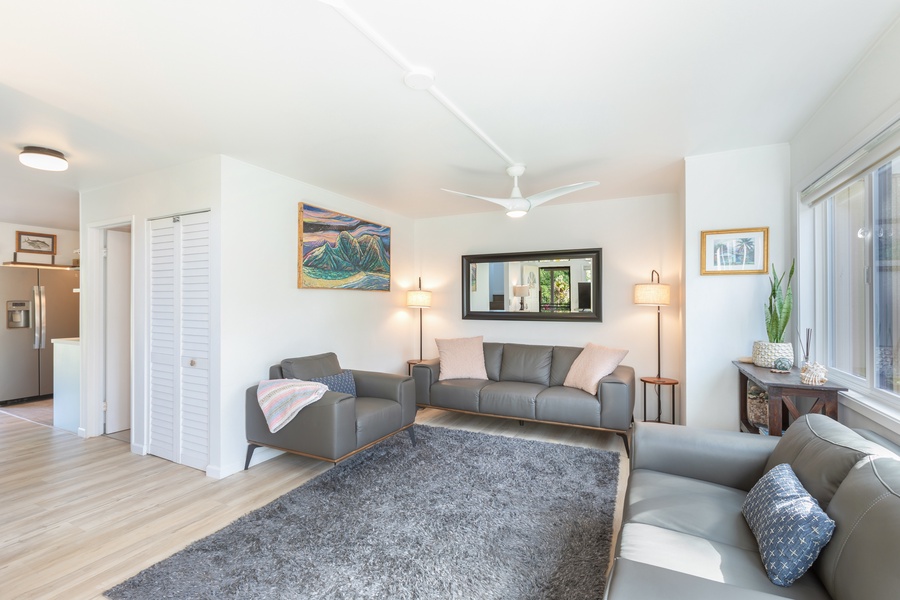 Spacious main living room with cozy seating, large windows, and vibrant local art.
