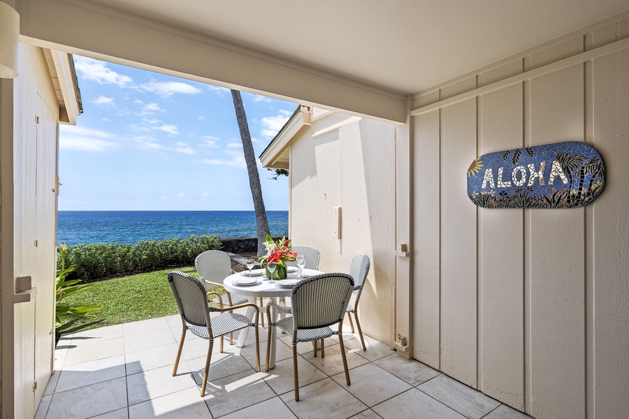 Covered lanai offers shade and ocean views, perfect for relaxing with morning coffee or cocktails.