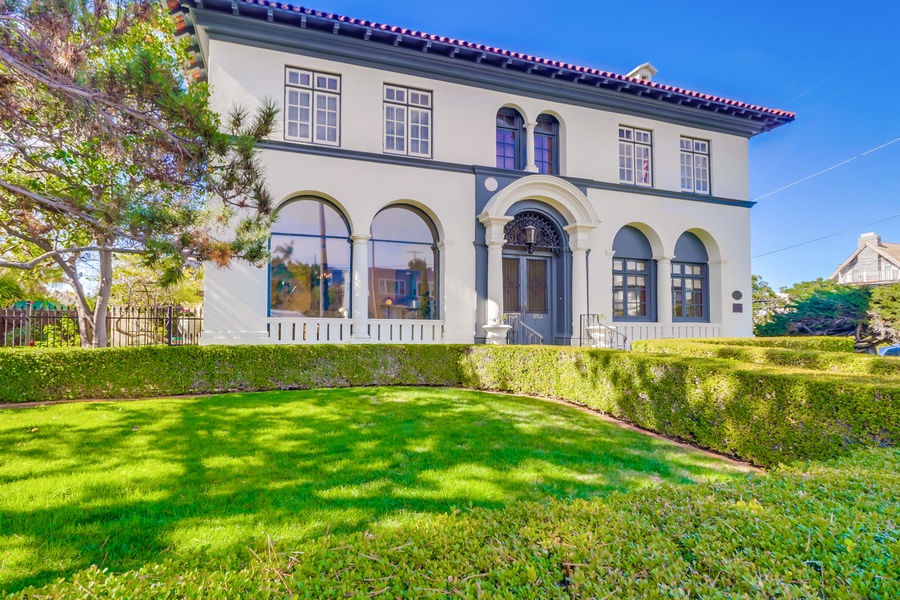 Elegant Mediterranean-style villa with manicured gardens and classic architectural details in a peaceful neighborhood setting.