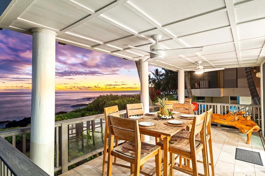 Covered lanai with dining set, perfect for sunset meals by the sea.
