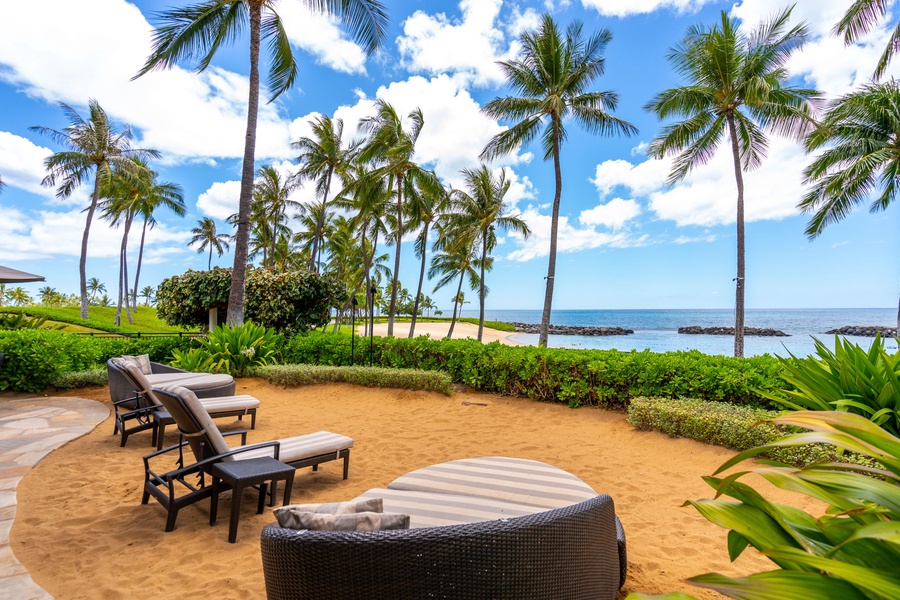 Beachfront paradise awaits with swaying palms and pristine sand just steps from your private terrace seating.