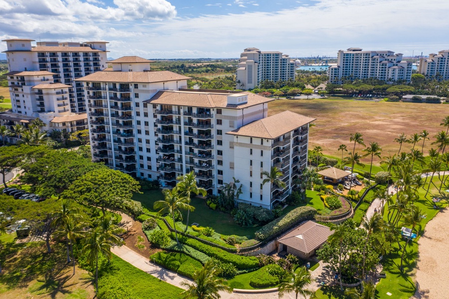 Resort complex surrounded by lush tropical landscaping and open spaces in a scenic coastal development area.