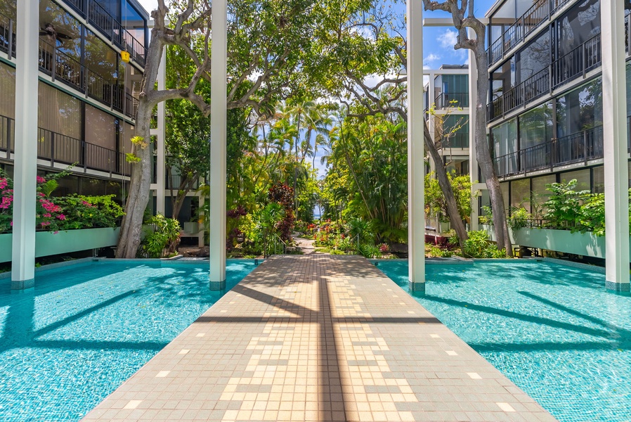 Stroll around the community pool surrounded by lush foliage.