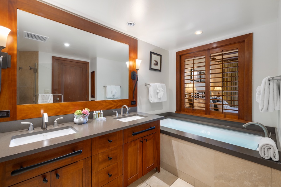 The primary guest bathroom with a luxurious soaking tub and walk-in shower.