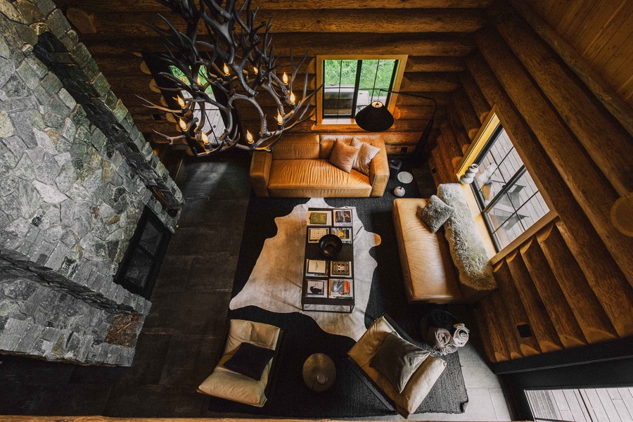 Gather in the cozy open living space beneath vaulted log-beam ceilings.