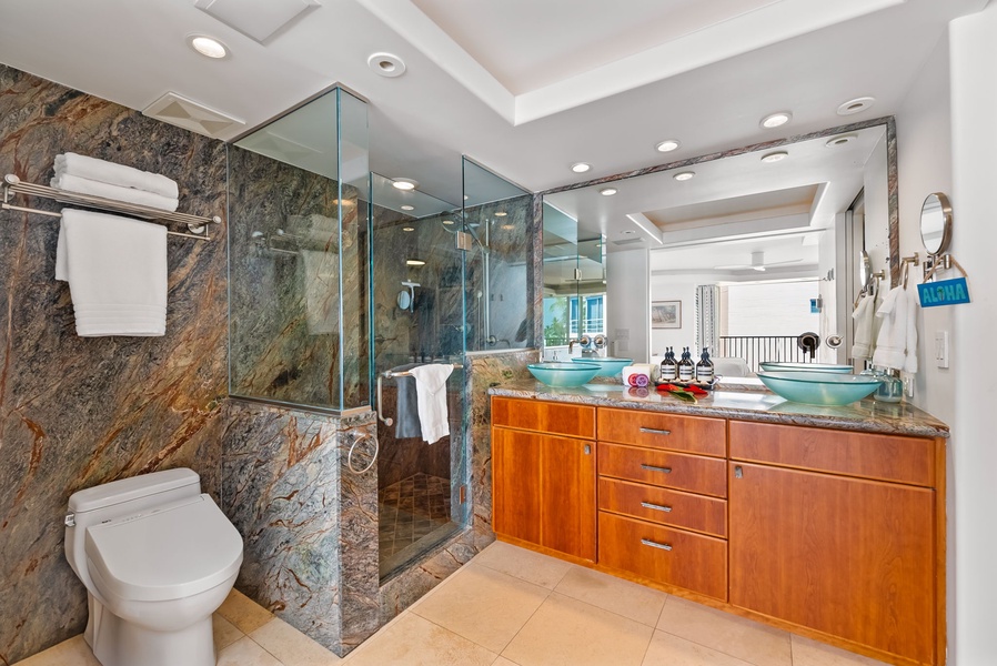 Elegant bathroom with natural stone accents and modern fixtures, providing a stylish and refreshing retreat.