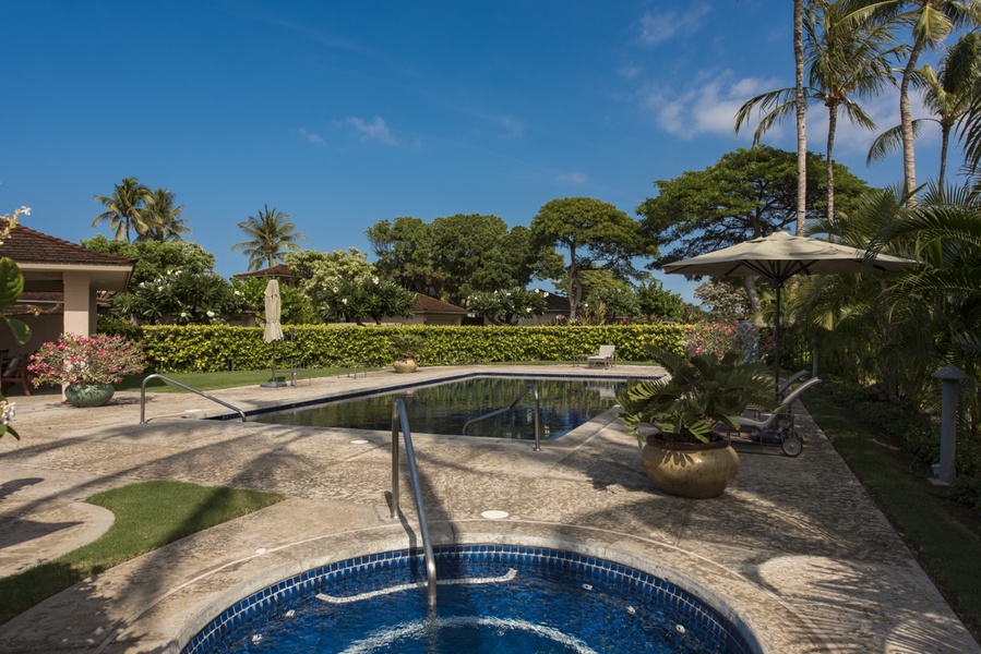 Relax in the hot tub with sparkling blue waters and tropical gardens creating the perfect outdoor sanctuary.