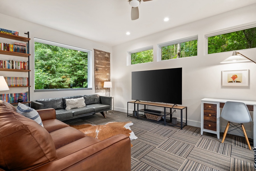 Laid-back lounge with leather seating, board games, and natural light—perfect for movie nights or mid-day reading.