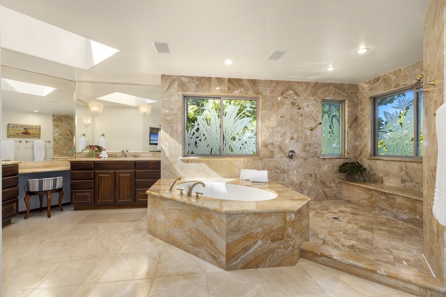 The shower/tub combo is enclosed with decorative glass doors