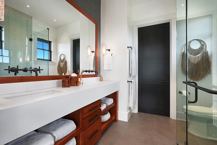 Guest ensuite bathroom with dual vanities is a luxury retreat.