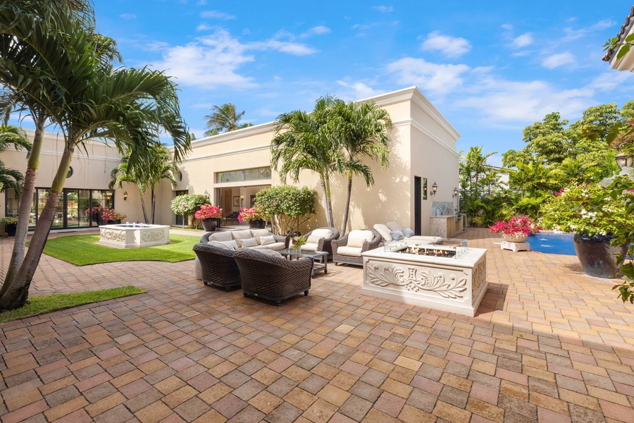 Outdoor lanai with a luxurious lounge area, perfect for entertaining or relaxation under the palm trees.