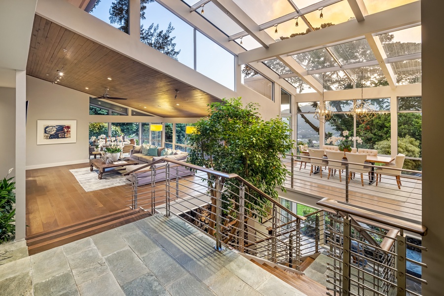 Striking architectural design connects living levels with open sightlines and garden views throughout.