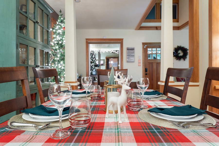 Dining table set with elegant holiday decor, perfect for a Christmas feast.