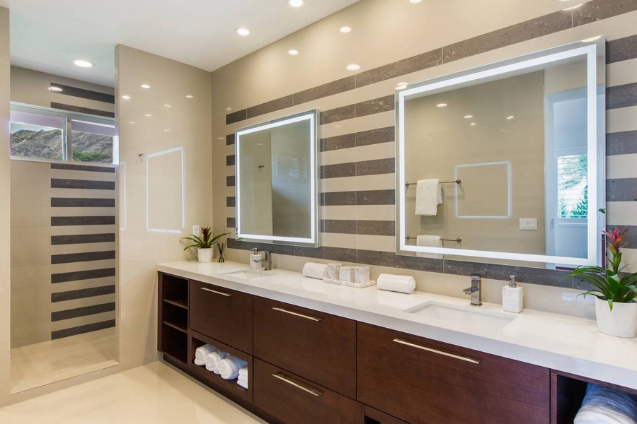 A wood-slatted wall warms the double vanity and walk-in shower.