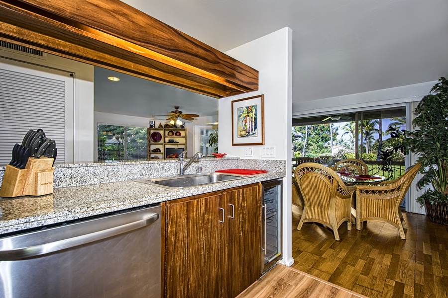 Enjoy cooking a meal in the fully equipped kitchen, which features a breakfast bar with seating for three