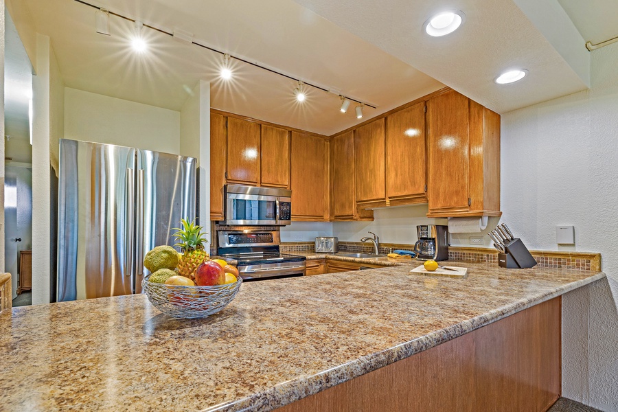 Kaanapali Shores 544’s kitchen boasts stainless steel appliances and spacious counters for meal prep.