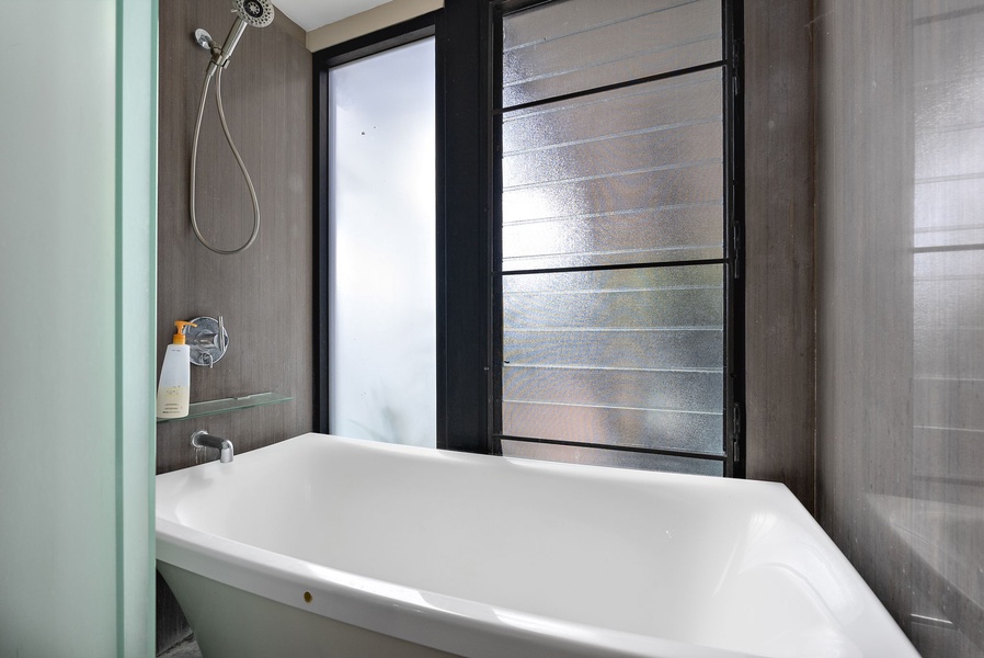 A bright and stylish bathtub with frosted privacy glass, perfect for a relaxing soak.