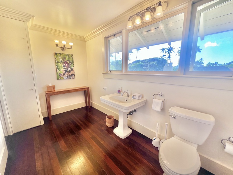 Bright and spacious bathroom with a vintage flair, dual vanities, and a soaking tub for relaxation