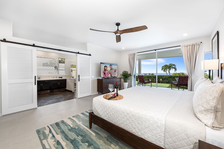 Oceanview primary suite with direct lanai access and calming décor, offering a luxe private haven for deep rest and connection.