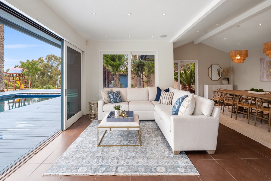 Living area 2 open to the pool and backed by formal dining room