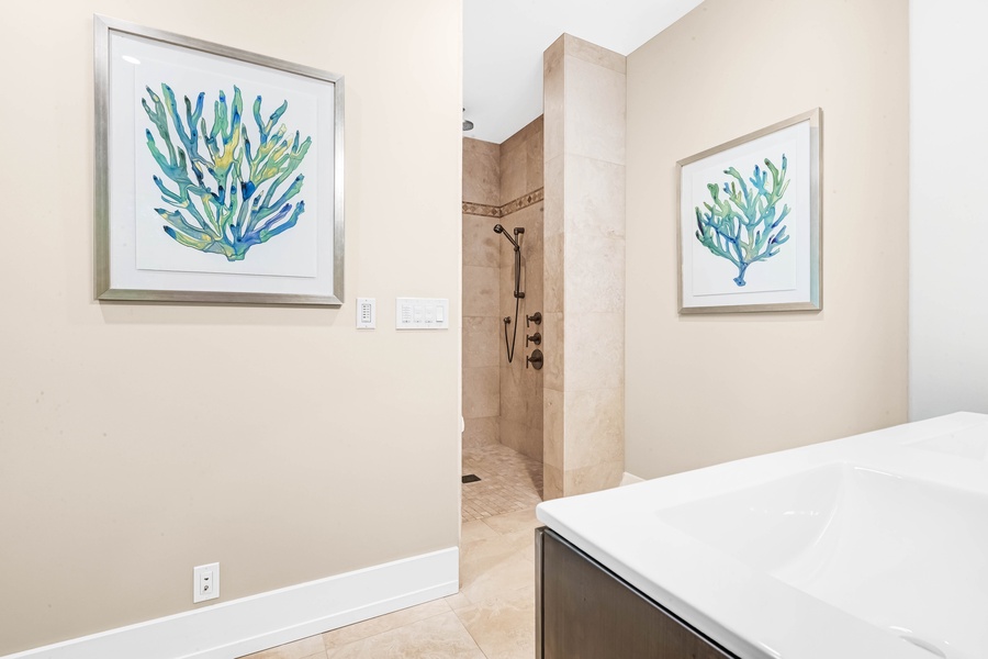 Guest suite en-suite featuring a walk-in shower and calming tones.