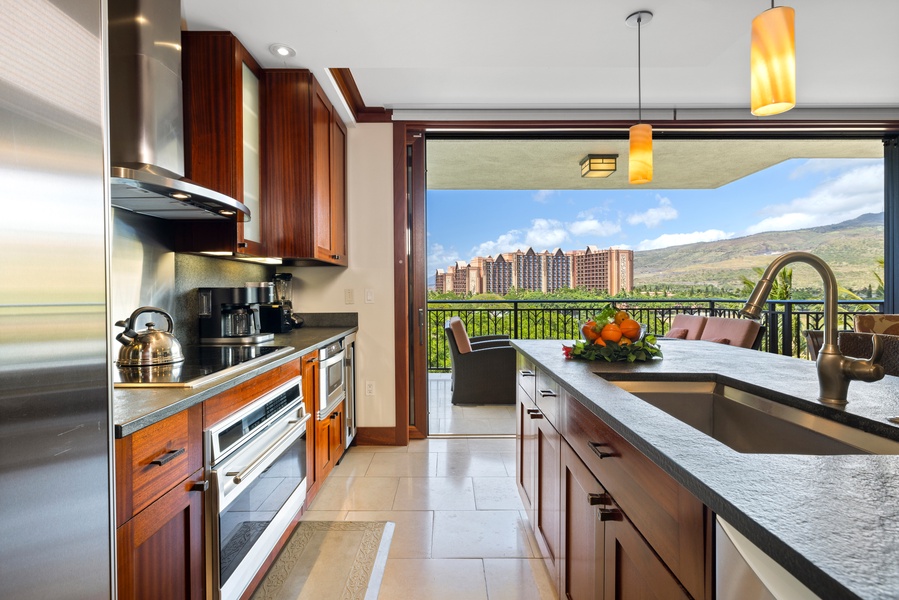 The kitchen features stainless steel appliances and opens up to a living area for easy entertaining.