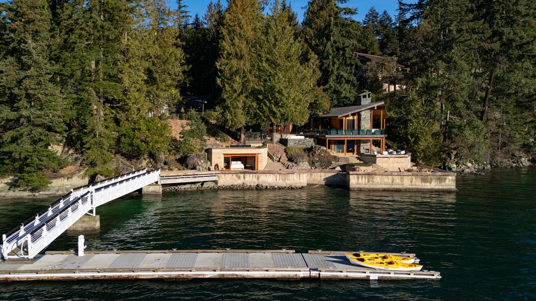 Stunning lakefront property with private dock and kayak access, nestled among towering evergreens for the ultimate waterfront retreat.