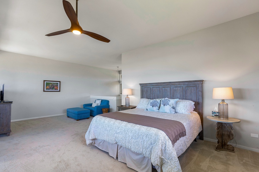 This inviting bedroom features a king-size bed and modern ceiling fan, providing comfort and style.