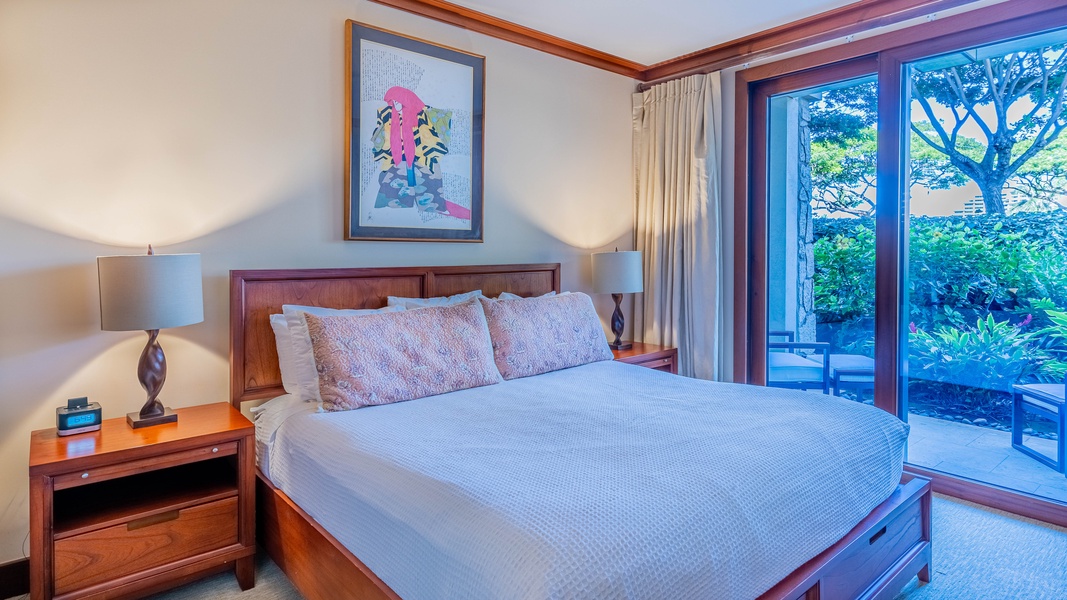 The primary guest bedroom features dual nightstands with lamps, dresser and TV.