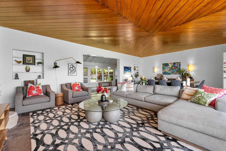Stylish mid-century flair and cozy seating invite family conversations, board games, or relaxing after a day at Lanikai Beach.