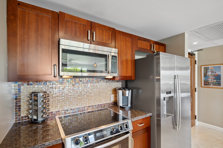 The sleek Bosch appliances and mosaic backsplash at Honua Kai Konea 204 add modern charm to this chef-ready kitchen.