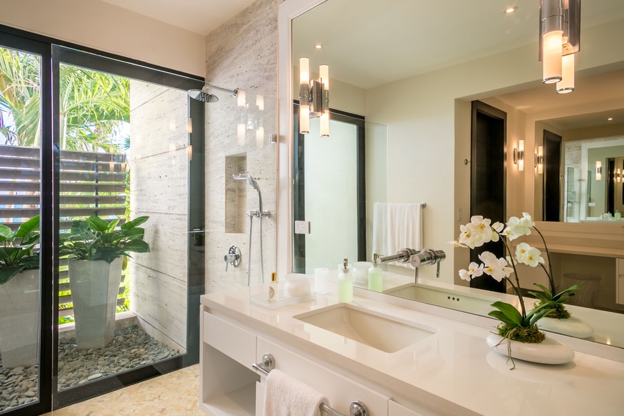 Ensuite bathroom with a sleek vanity and private outdoor shower.
