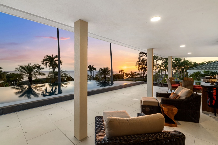 Unwind as the sky lights up with color from your cozy lanai seat.