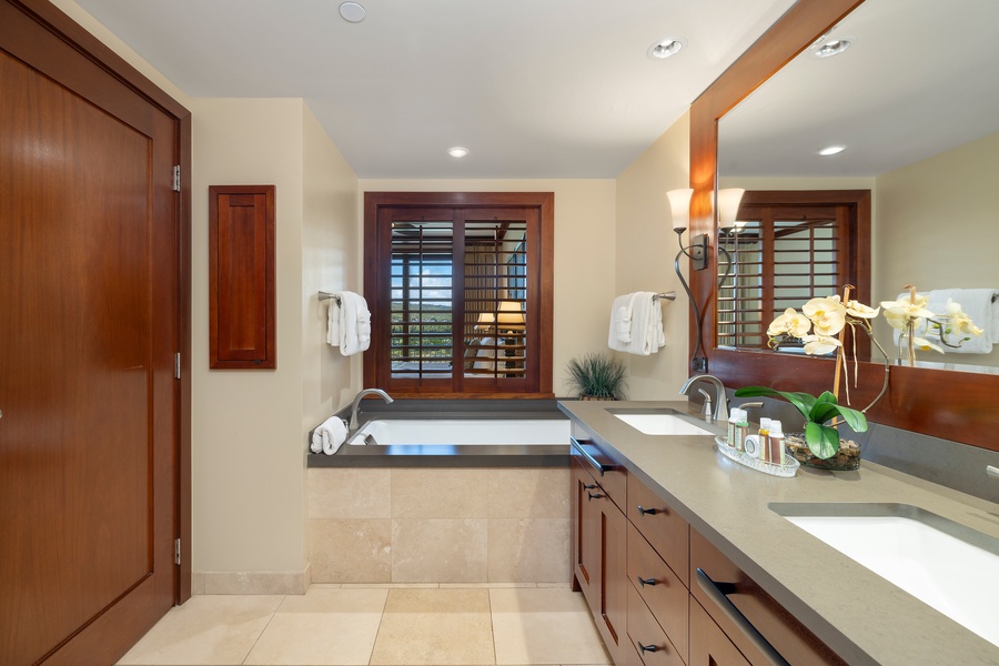 The ensuite bathroom with dual vanities and a soaking tub/shower combo.