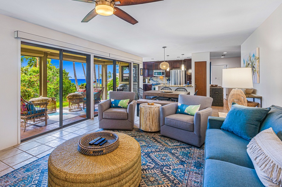 This open-concept living area connects seamlessly to the lanai, providing a perfect space to unwind and enjoy the ocean breeze.