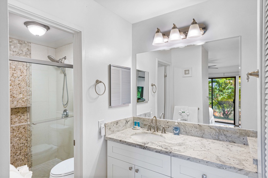 A bright bathroom with a clean, modern design and a spacious vanity for all your essentials.