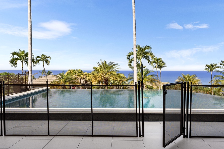 A picture-perfect setting for a swim, with sweeping tropical foliage and blue waters beyond.