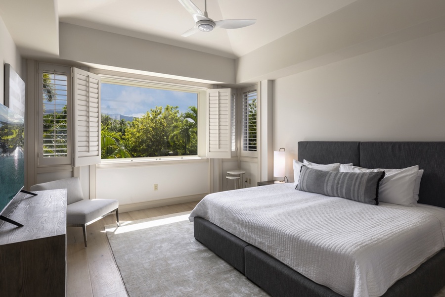 Third bedroom displayed in the king bed set up while showcasing spectacular views of Mt. Hualalai and abundant natural light
