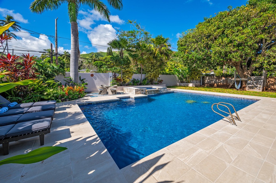Lush backyard with large pool deck and pool give you all the feels of having your own private mini hotel!  (Note: Upper pool area is apart of the pool and NOT a spa)