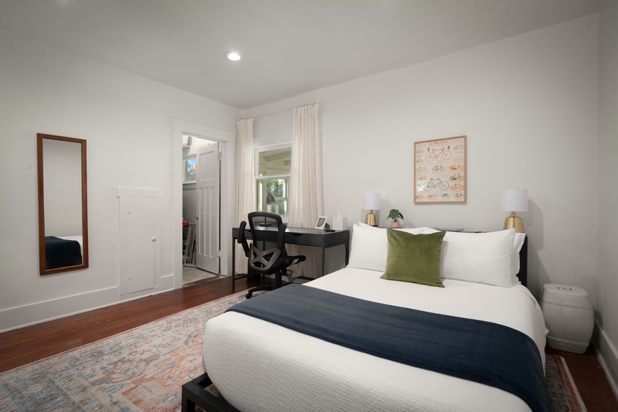 Drift off comfortably in this bright bedroom with plush bedding and a dedicated desk.