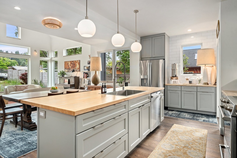 Stylish pendant lighting highlights the bright, functional kitchen layout.