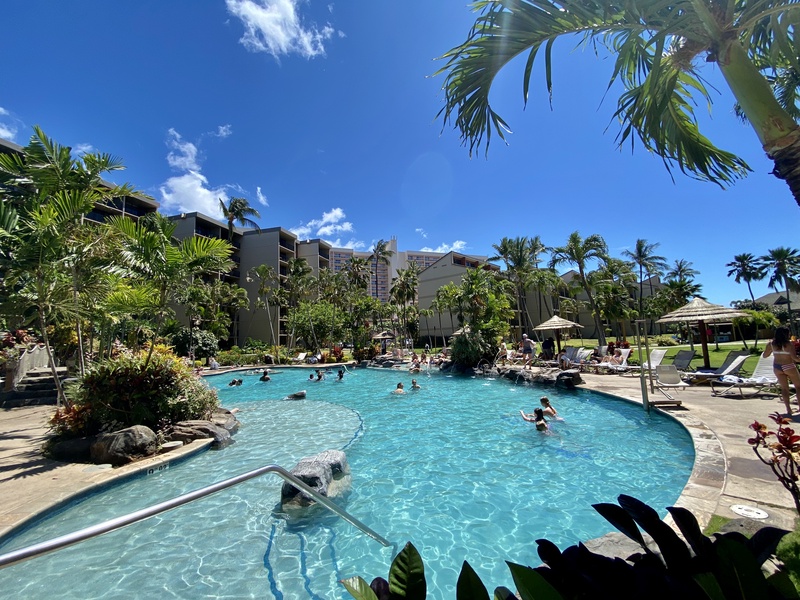 Take a refreshing dip in the resort-style pool, surrounded by tropical landscaping, perfect for a leisurely day under the Hawaiian sun.