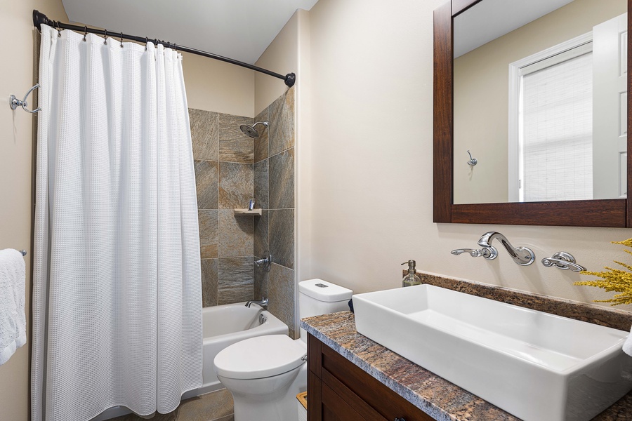 A shower-tub combo off the third bedroom, ready for a rinse or a long soak.