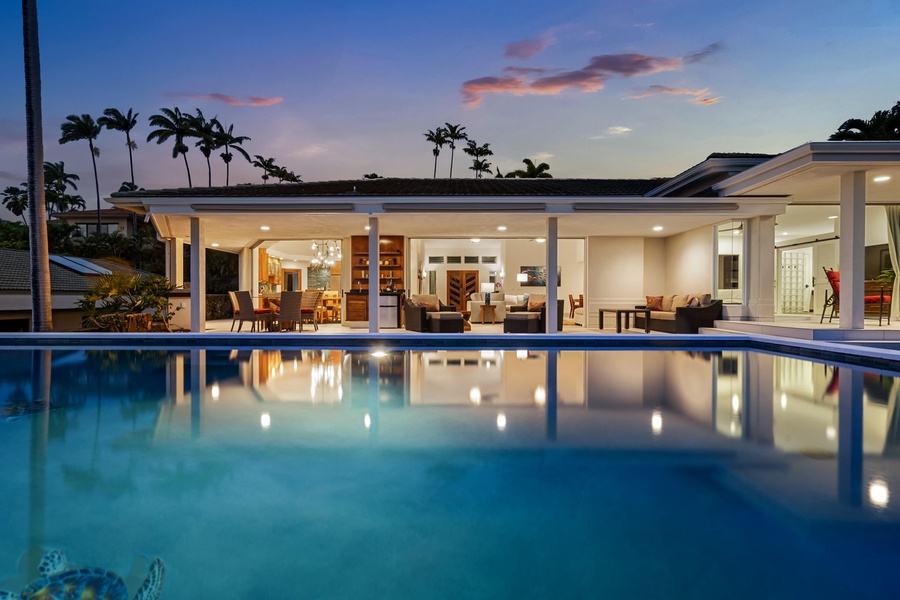 Dusk brings magic to the pool, lanai, and softly lit interiors.